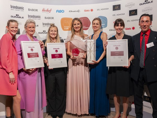 Wellness Aphrodite: Sensoria Dolomites among the winners Seven people posing with certificates and awards at an awards ceremony.