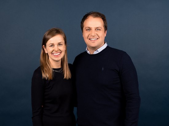 Places of spiritual power, favourite rooms, hosts with heart Portrait of a smiling man and woman against blue background