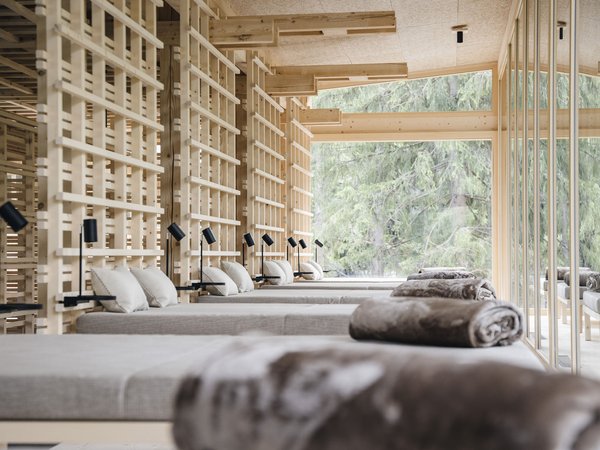 Wellness Aphrodite: Sensoria Dolomites among the winners Modern spa waiting area with wooden structure and loungers with pillows