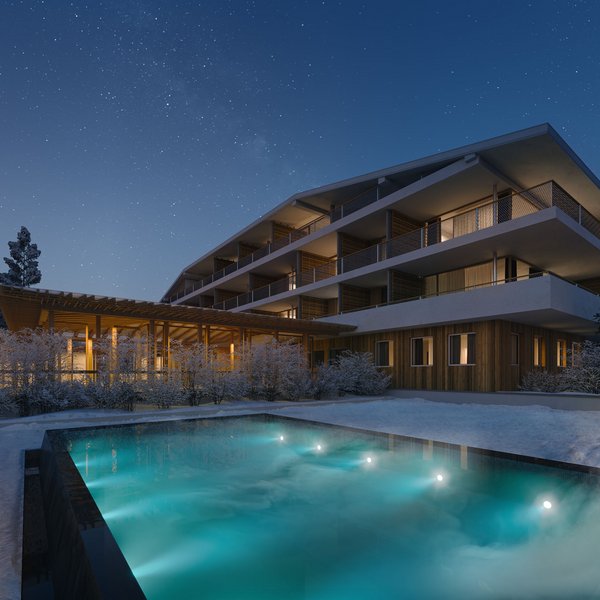 Sensoria Dolomites: il vostro hotel sull’Alpe di Siusi Hotel moderno con piscina esterna illuminata e paesaggio innevato di notte