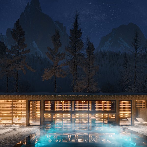 Sensoria Dolomites: il vostro hotel sull’Alpe di Siusi Piscina riscaldata di notte in paesaggio montano innevato con padiglione in legno illuminato