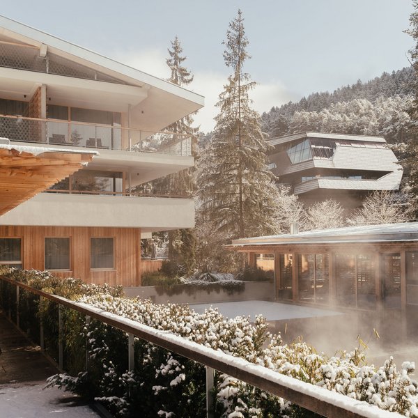 Sensoria Dolomites: il vostro hotel sull’Alpe di Siusi Hotel innevato con terrazza e montagne sullo sfondo