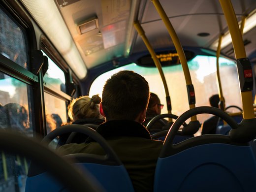 How to reach your getaway on Alpe di Siusi in South Tyrol People sitting in a bus with sunlight coming through the windows