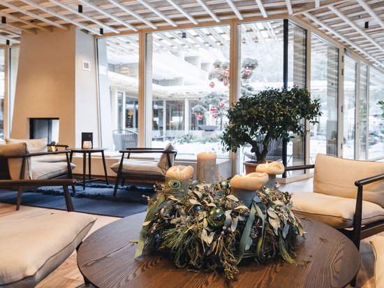 Luxury for the Soul. Nature hotel in South Tyrol. Cozy seating area with candles and decoration on table in modern room