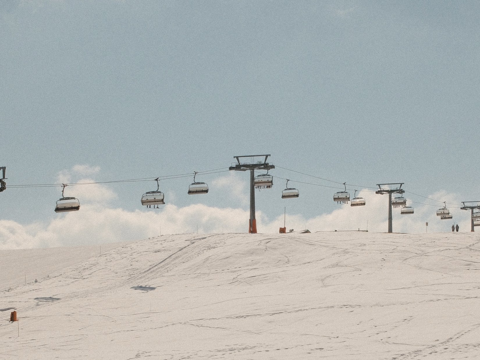 Offers – holidays in the Dolomites UNESCO World Heritage Chairlift over snowy ski slope under clear sky