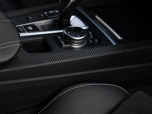 How to reach your getaway on Alpe di Siusi in South Tyrol Gear shift and control inside a car with black leather and carbon fiber interior