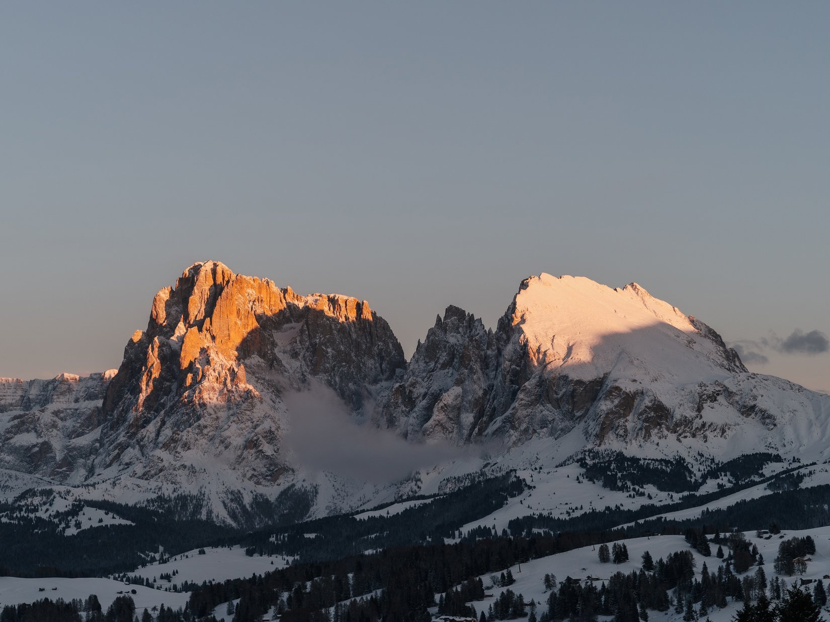 Offers – holidays in the Dolomites UNESCO World Heritage Snow-covered mountains at sunset with orange sunlight