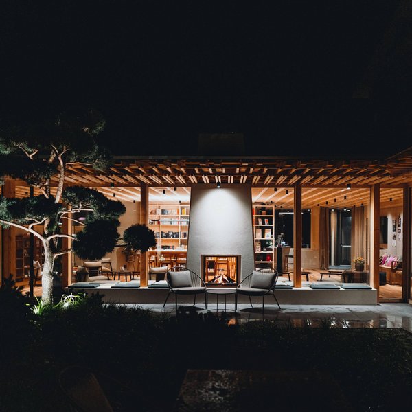 Romantic short break for couples – Sensoria Dolomites Modern illuminated house with fireplace and garden at night