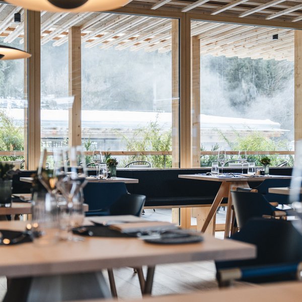 Sensoria Dolomites: Flitterwochen in Südtirol Modernes Restaurant mit Holzelementen und gedeckten Tischen