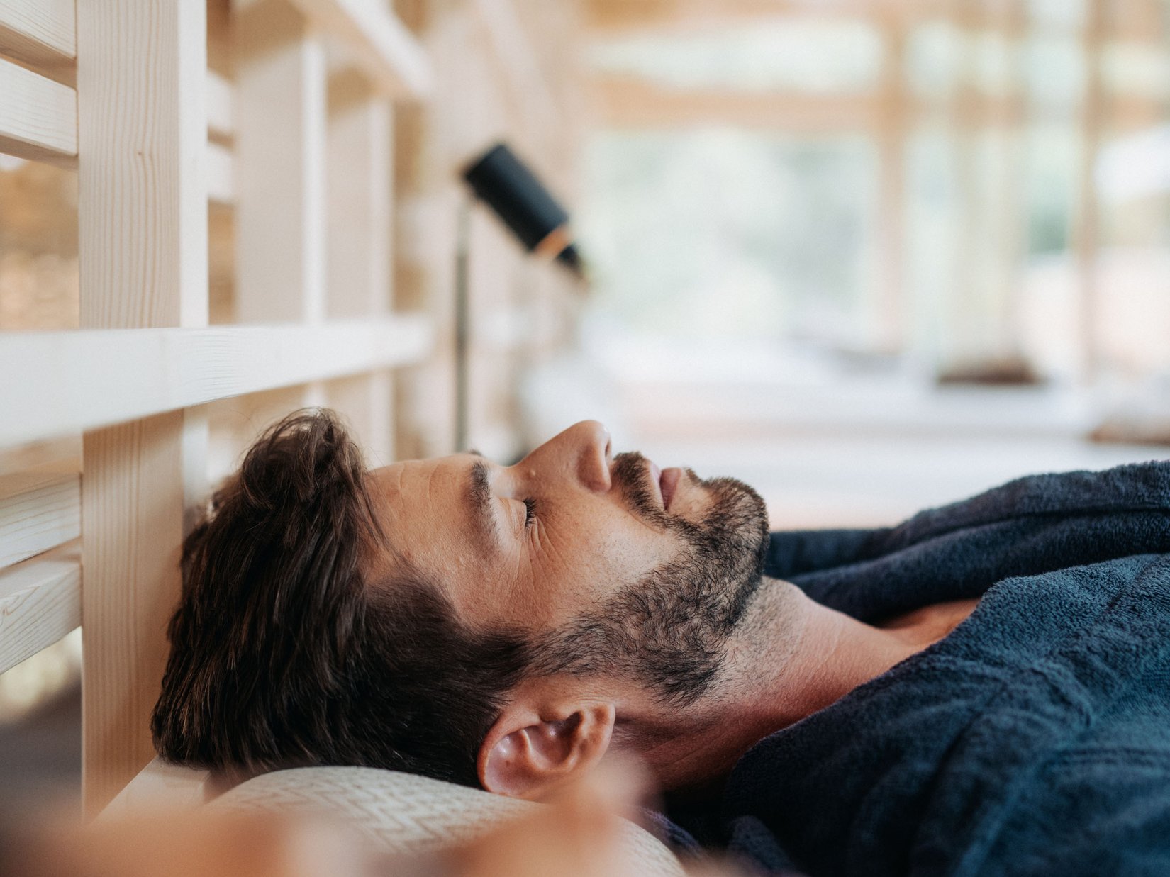 Luxury for the Soul: your adults-only hotel in the Dolomites Man relaxing with eyes closed lying on a spa lounge