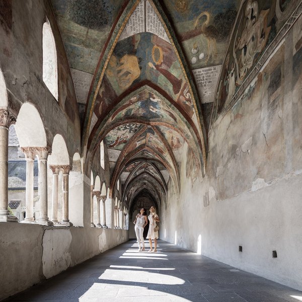 Sensoria Dolomites: much more than a hotel in South Tyrol Two women explore a Gothic cloister with painted arches and windows