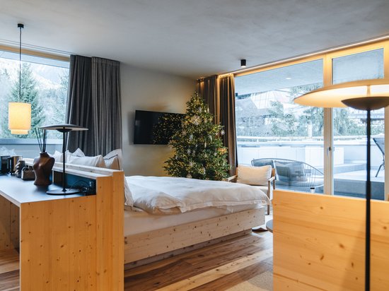 Place of spiritual energy – your favourite room Cozy hotel room with Christmas tree and large window showing mountain view