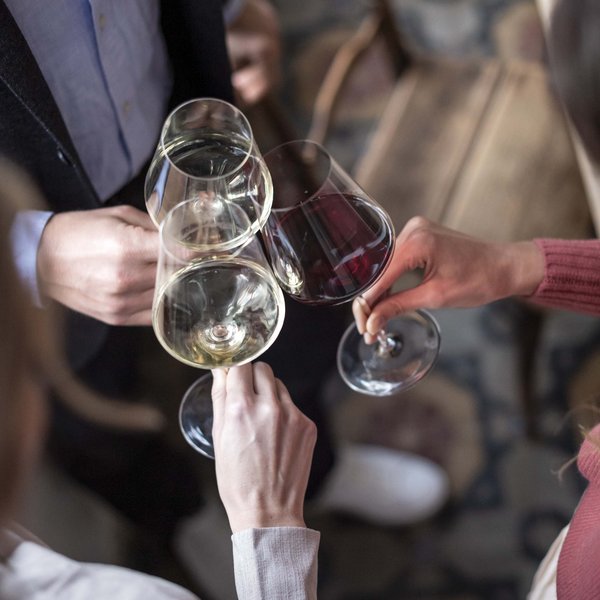 Sensoria Dolomites: much more than a hotel in South Tyrol Three people clinking red and white wine glasses