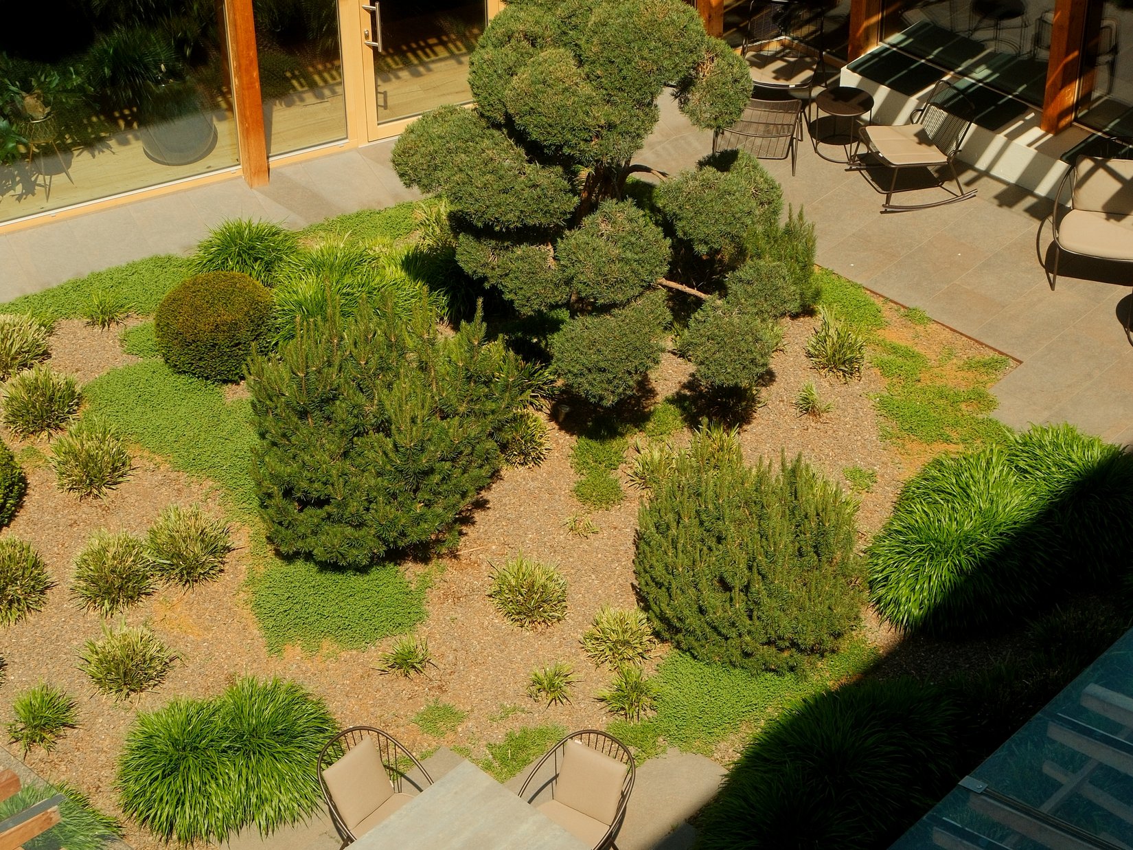 Offers – holidays in the Dolomites UNESCO World Heritage View of a courtyard with garden and seating area with table and chairs